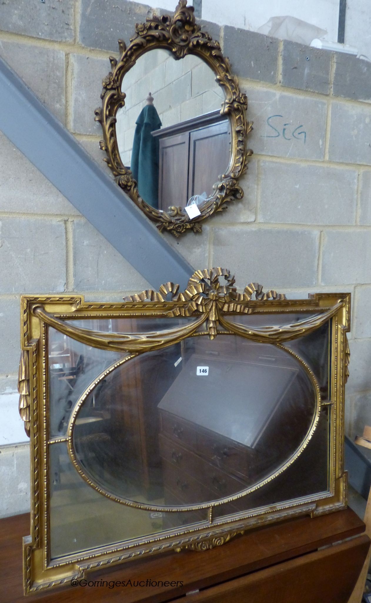 A rectangular Adam style gilt framed wall mirror, width 91cm, height 66cm, together with a smaller oval gilt wall mirror